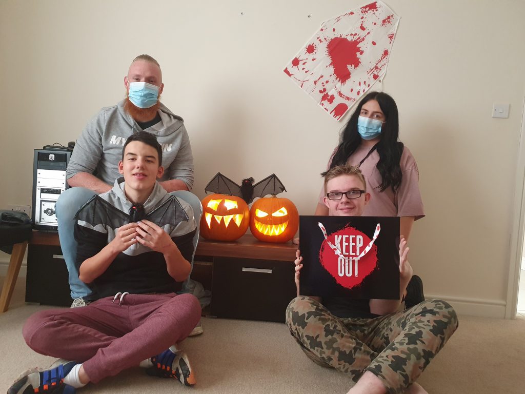 People we support and staff posing with their pumpkins 